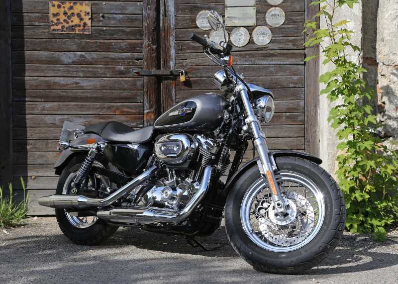 Parked Harley Motor near Wooden Door