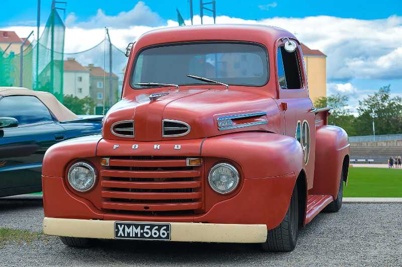 Parked vintage red ford utility truck