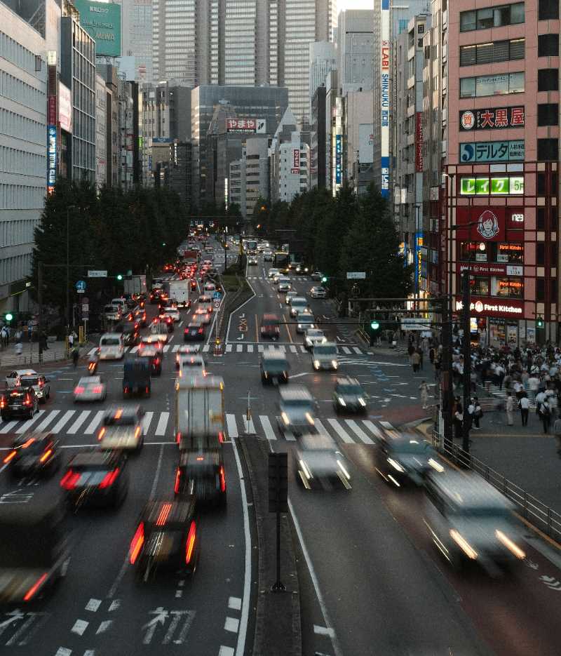 a busy city street filled with lots of traffic - jigsaw puzzle