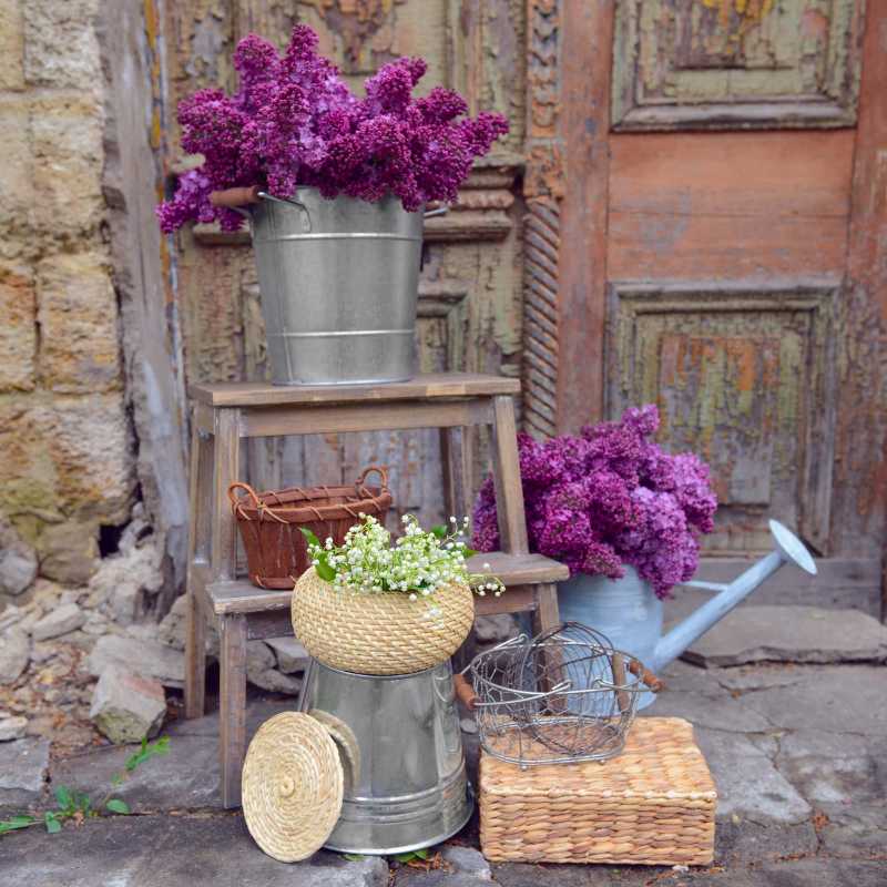 Purple lilac and maylily flowers on old porch