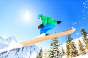 person wearing green jacket riding snow skis - jigsaw puzzle