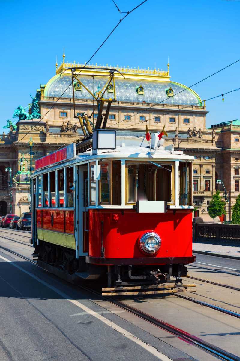 Red vintage tram in the old streets of prague