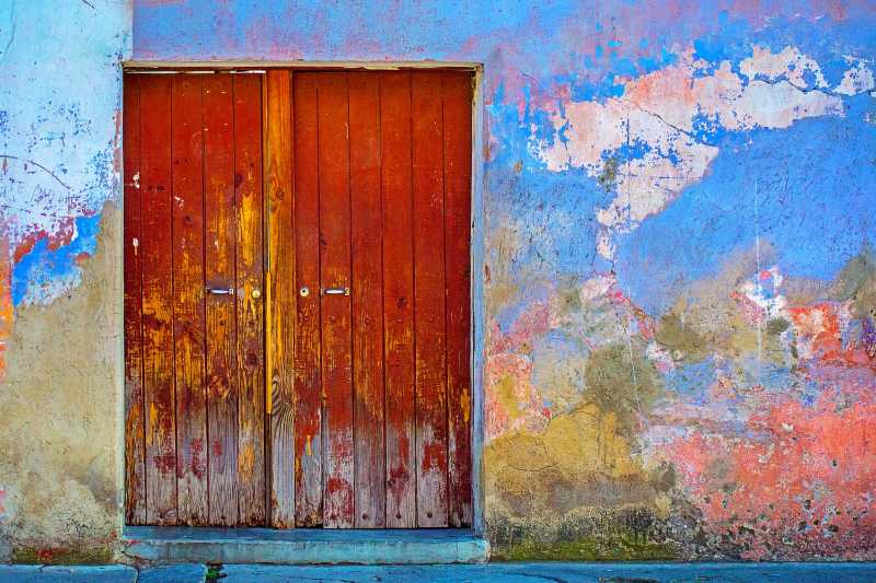 red wooden door of blue red and brown painted wall - jigsaw puzzle