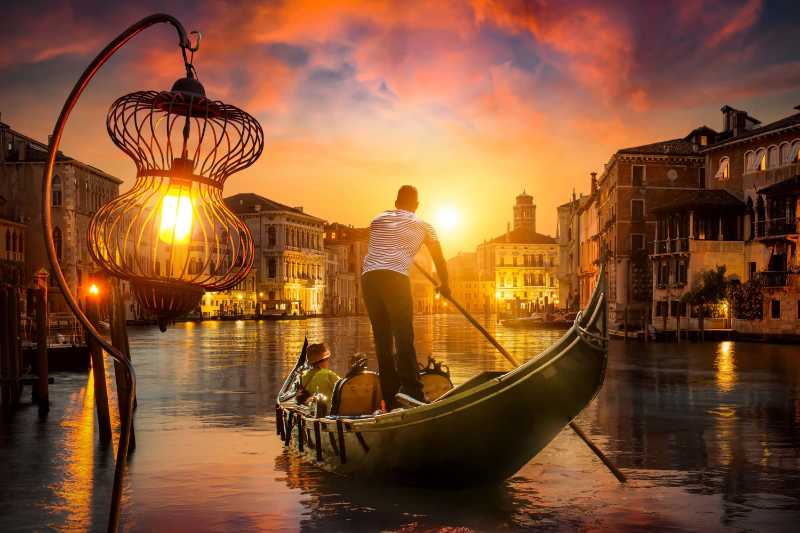 Romantic sunset gondola ride on the canals of Venice