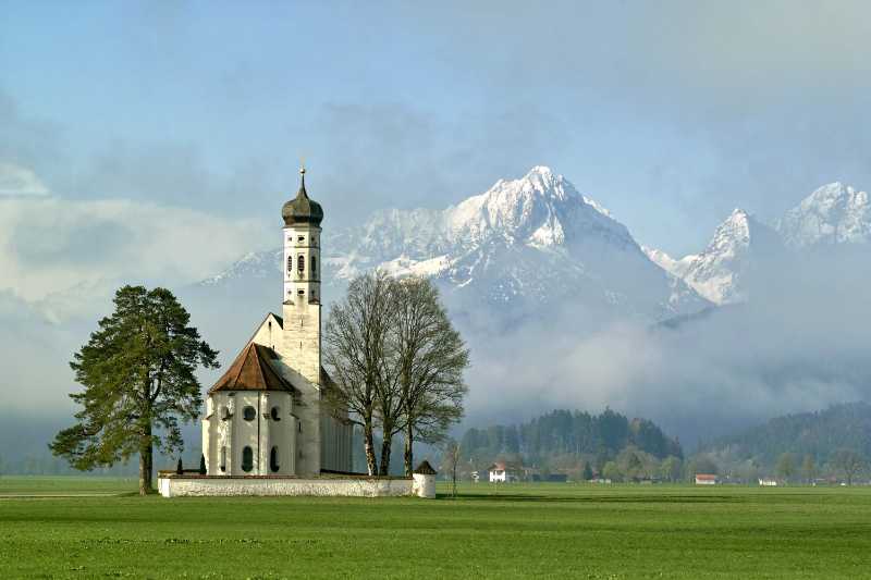 Saint Coloman Chapel near Schwangau with snow-capped mountains in the background