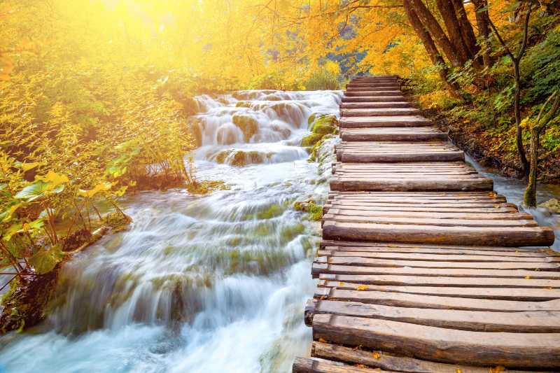 Scenic waterfalls and wooden path in Plitvice Lakes National Park