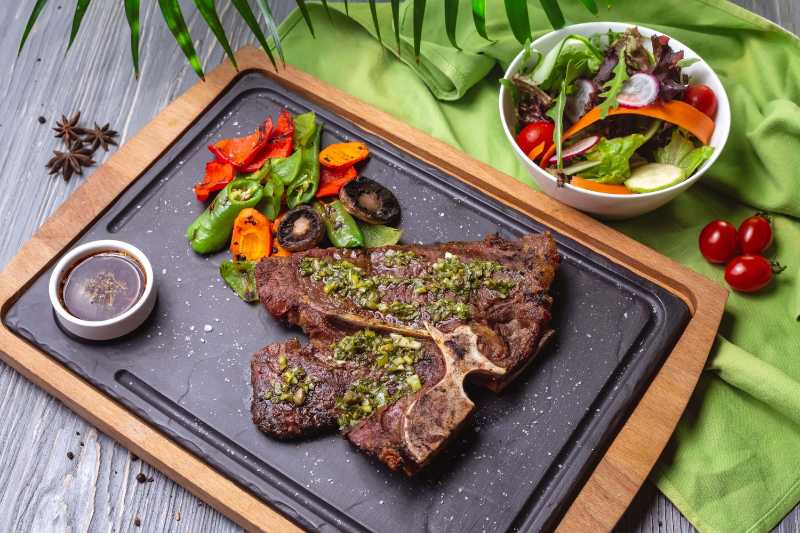 top view steak with grilled vegetables sauce