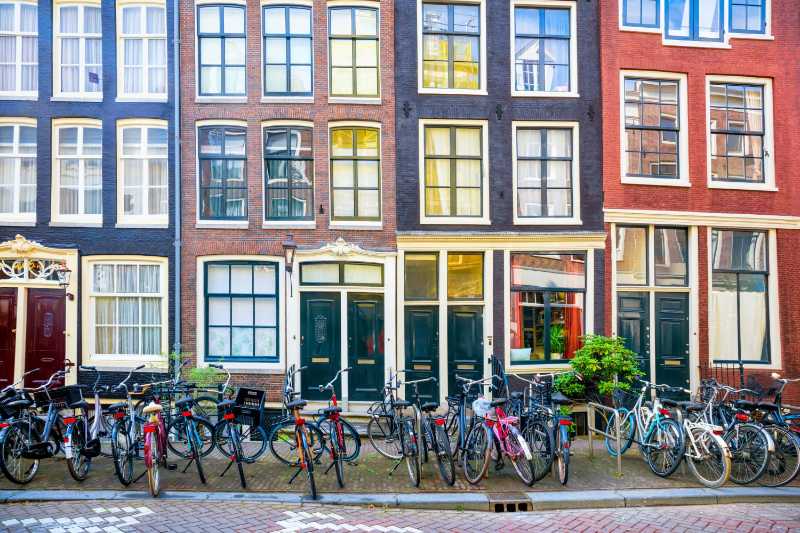Traditional street in amsterdam with many parked bicycles