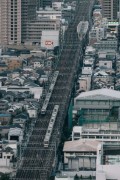 a very long metal bridge in a big city - jigsaw puzzle