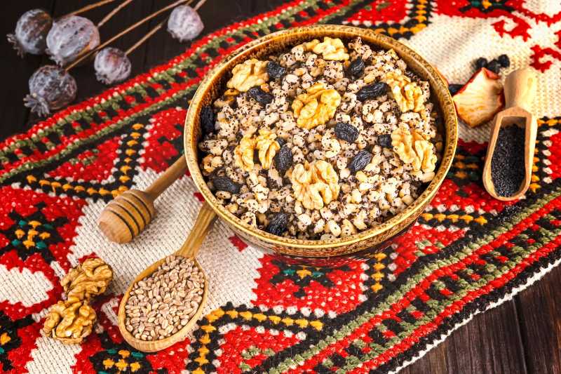 Ukrainian christmas dish kutia with nuts poppy seeds raisins on an embroidered towel