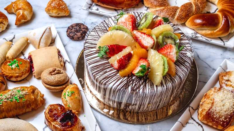 Vanilla cream fruit cake and pastries on the table