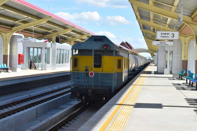 Vintage blue and yellow train on railroad station platform against sky