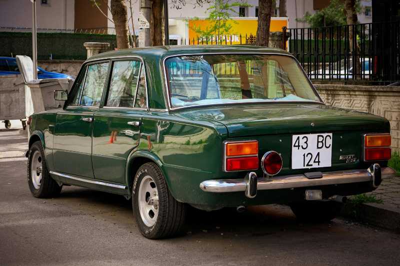 Grünes Oldtimer auf der Stadtstraße bei Tageslicht
