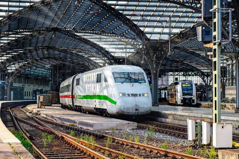 White and Green Train on Rail Tracks