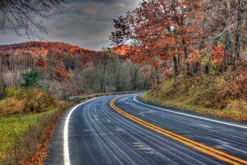 Winding Autumn Road Through Forested Mountains