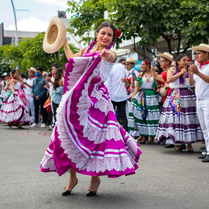 Women Wearing Patterned Folklore Dresses with Ruffles Dancing Outdoors