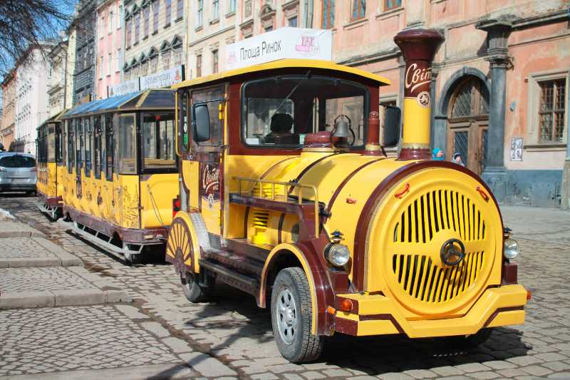 Yellow Tourist Road Train in European City Center